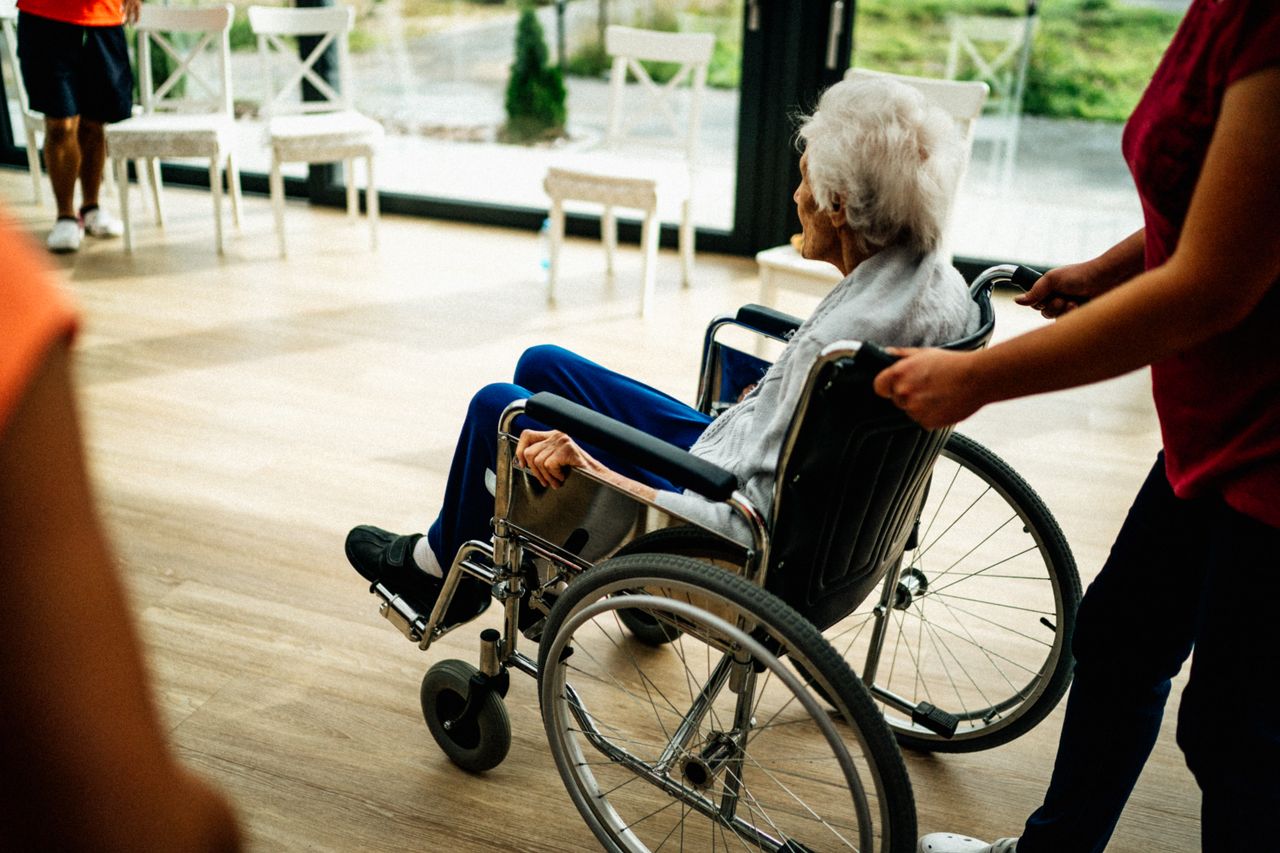 hero-img-01 A caregiver assists a senior adult in a wheelchair at a nursing home in Prague, Czech Republic.